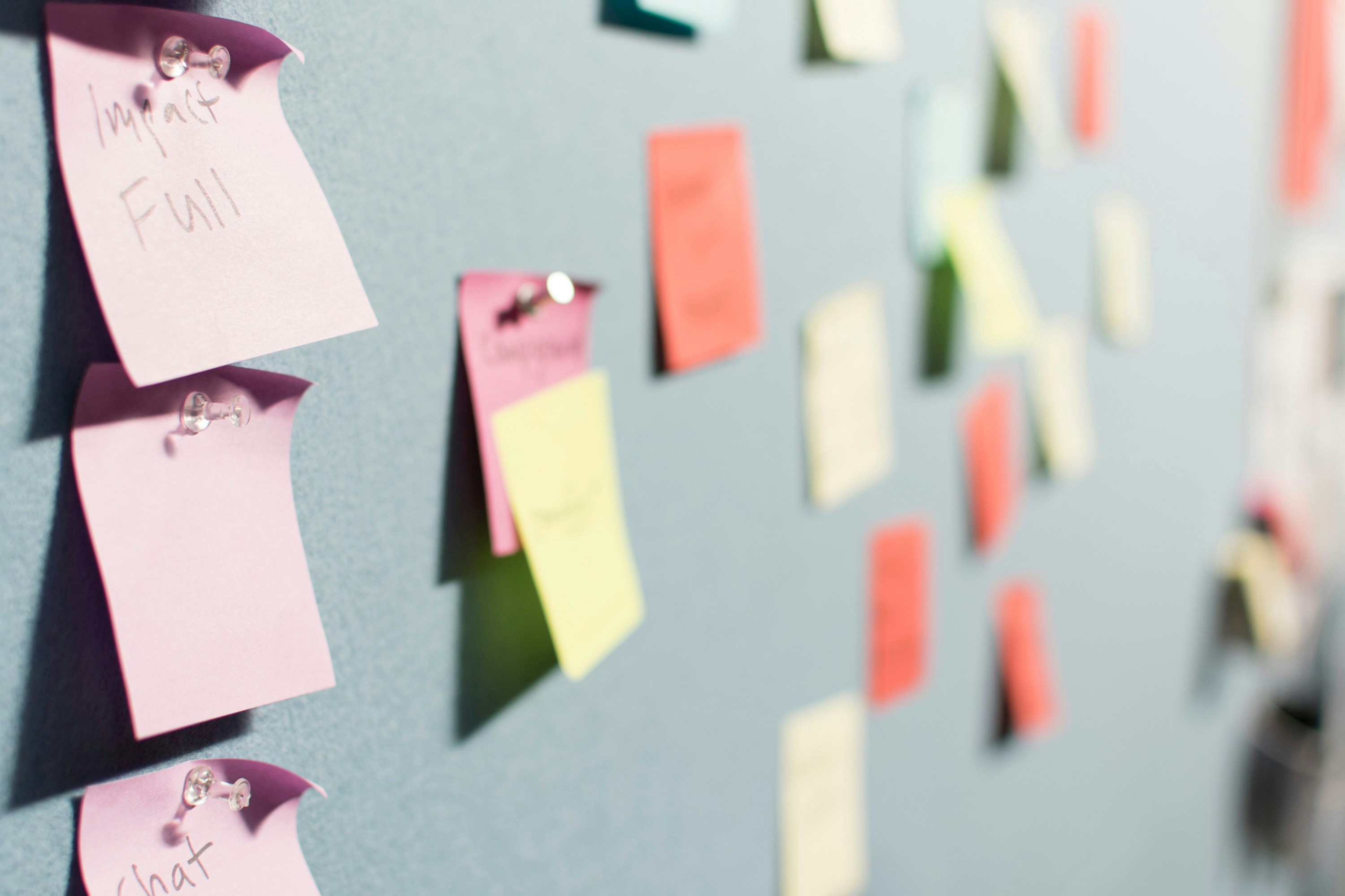 Een prikbord met post-it notes 